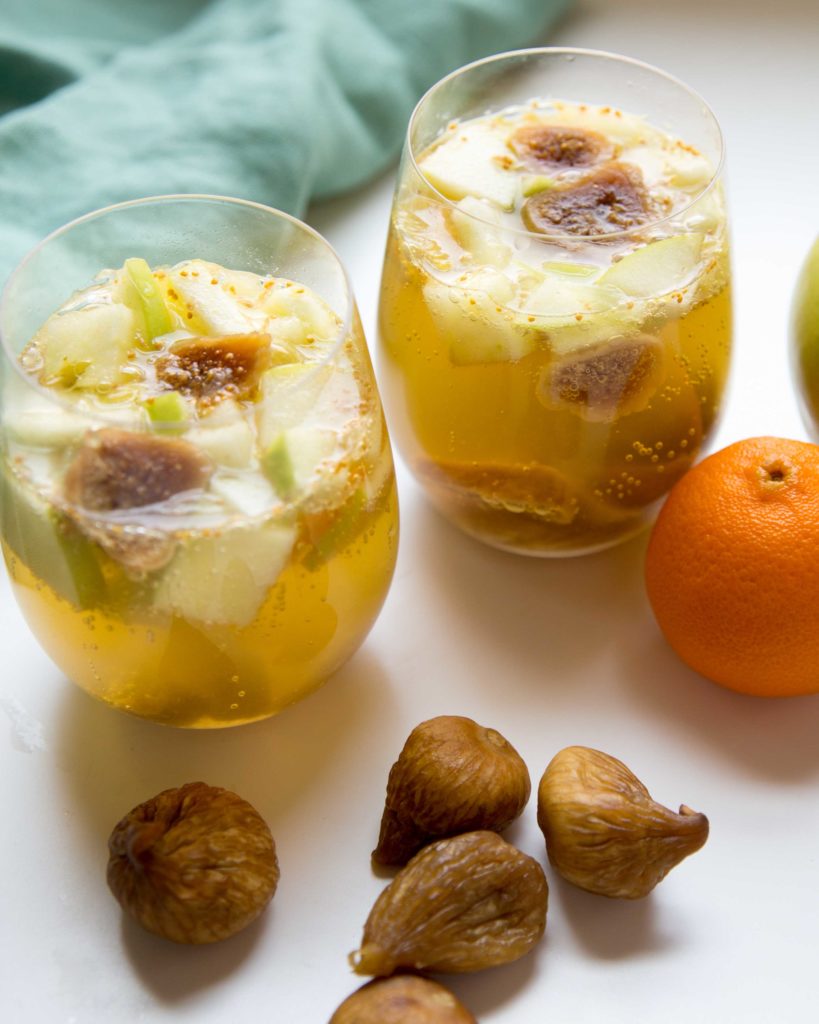 Fig sangria full of oozy fruit topped with ginger ale in cups and ready to sip