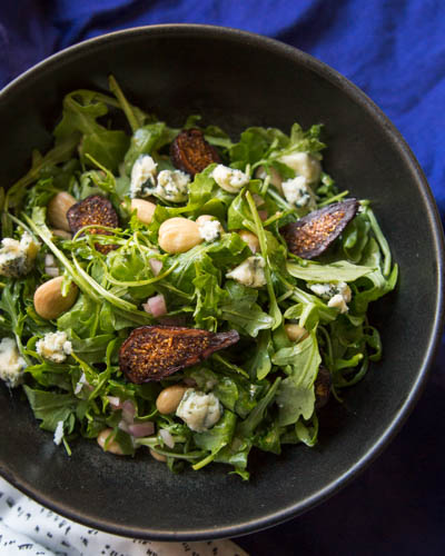 Baby arugula adds a slight peppery flavor to salad tossed together by Joanne Weir with dried figs, cabrales cheese, and Marcona Spanish almonds.