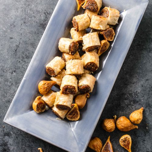 Desserts using phyllo: baklava-flavors in tiny cookies in a blue serving platter with Golden Figs around the plate.