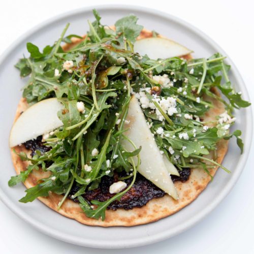 Switch up your salad routine and make lunch easy and light with arugula flatbread salad pizza. Prep mix-ins ahead of time for quick meals during the week.