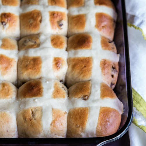 Celebrate Easter by baking this traditional hot cross buns recipe. Dried figs add a chewy sweet bite in the tender old fashioned hot cross buns recipe.