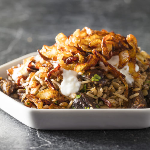 Mujadara, essentially Middle Eastern "rice and beans" is classic comfort food. Topped with crispy onions, this mujadara recipe also includes figs.
