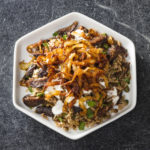 Mujadara, essentially Middle Eastern "rice and beans" is classic comfort food. Topped with crispy onions, this mujadara recipe also includes figs.