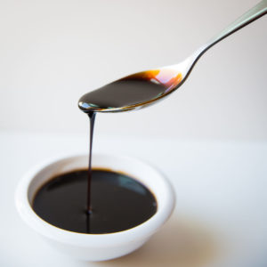 fig concentrate dripping out of a spoon
