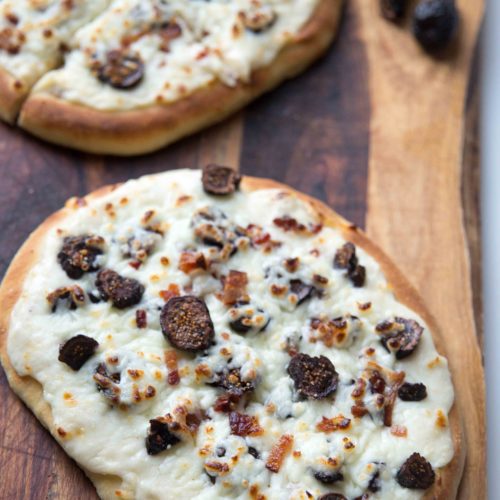 Tonight is pizza night with pizza on naan bread. Skip tomato sauce—top naan bread pizza with garlic parmesan pizza sauce with bacon & figs.