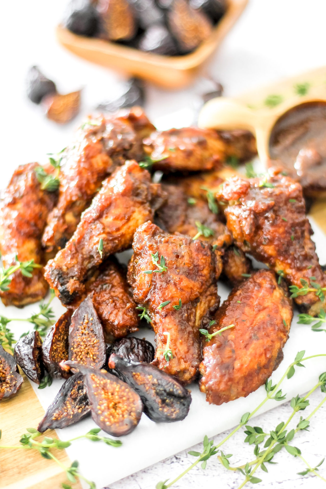 Figs on a plate with fig balsamic chicken wings.