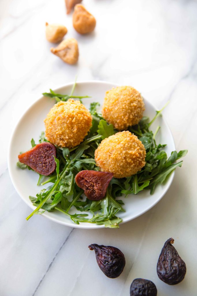 One of the tastiest appetizers just happens to use leftover risotto. This arancini recipe stuffs arborio rice balls with prosciutto, figs, and mozzarella.