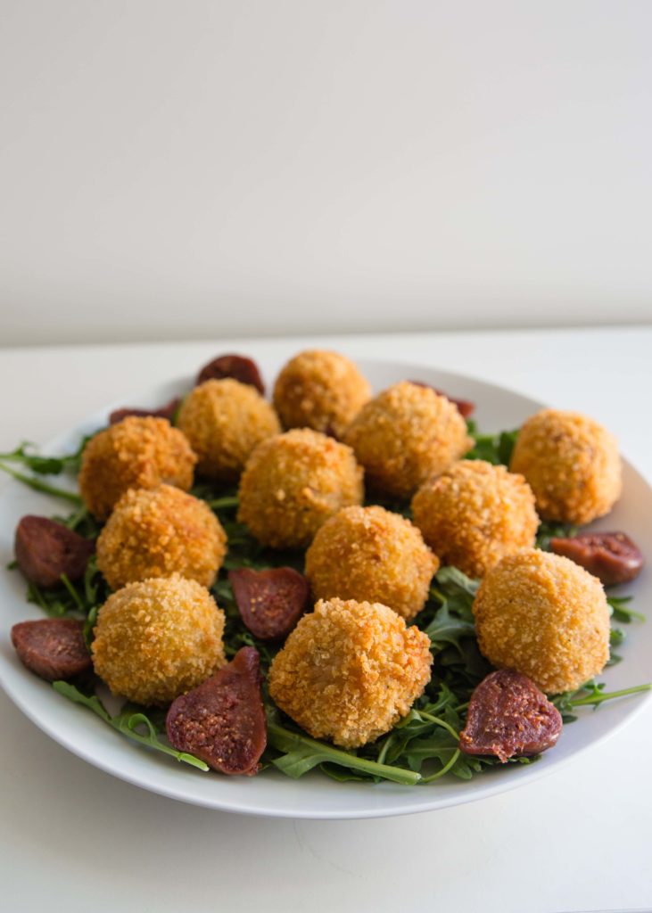 One of the tastiest appetizers just happens to use leftover risotto. This arancini recipe stuffs arborio rice balls with prosciutto, figs, and mozzarella. 