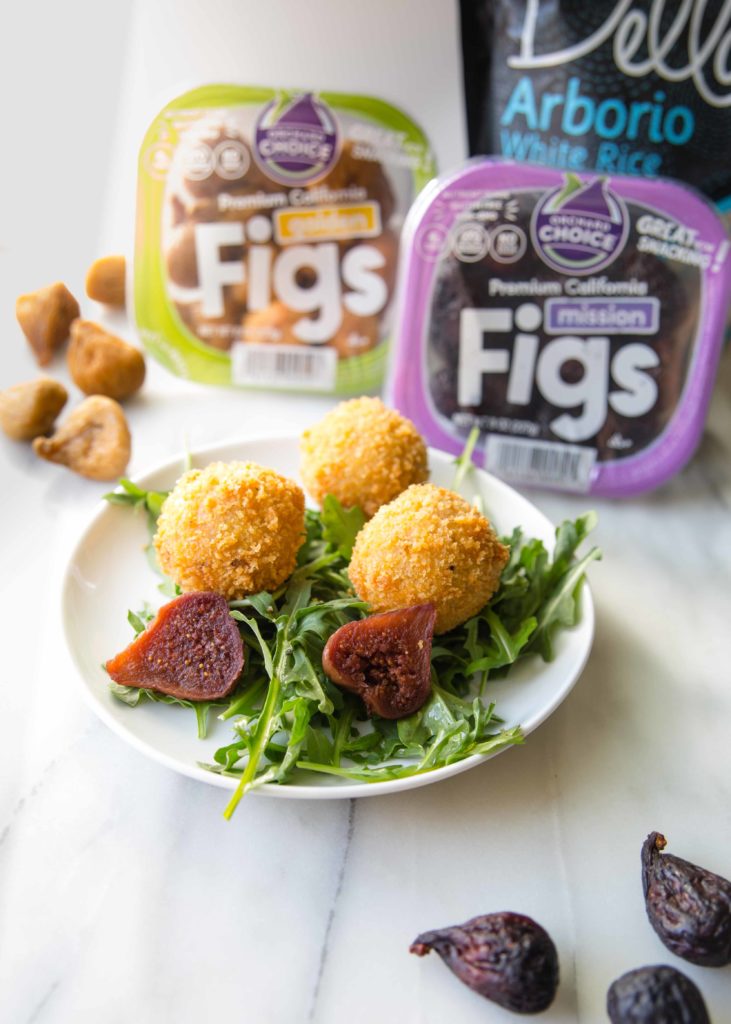 California short grain rice and California dried figs in their packaging with a plate of arancini.