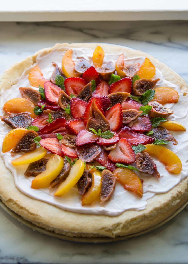 Fruit dessert lovers, make fruit pizza with sugar cookie dough. Top with stone fruits + dried figs for a fruit pizza recipe great in summer.
