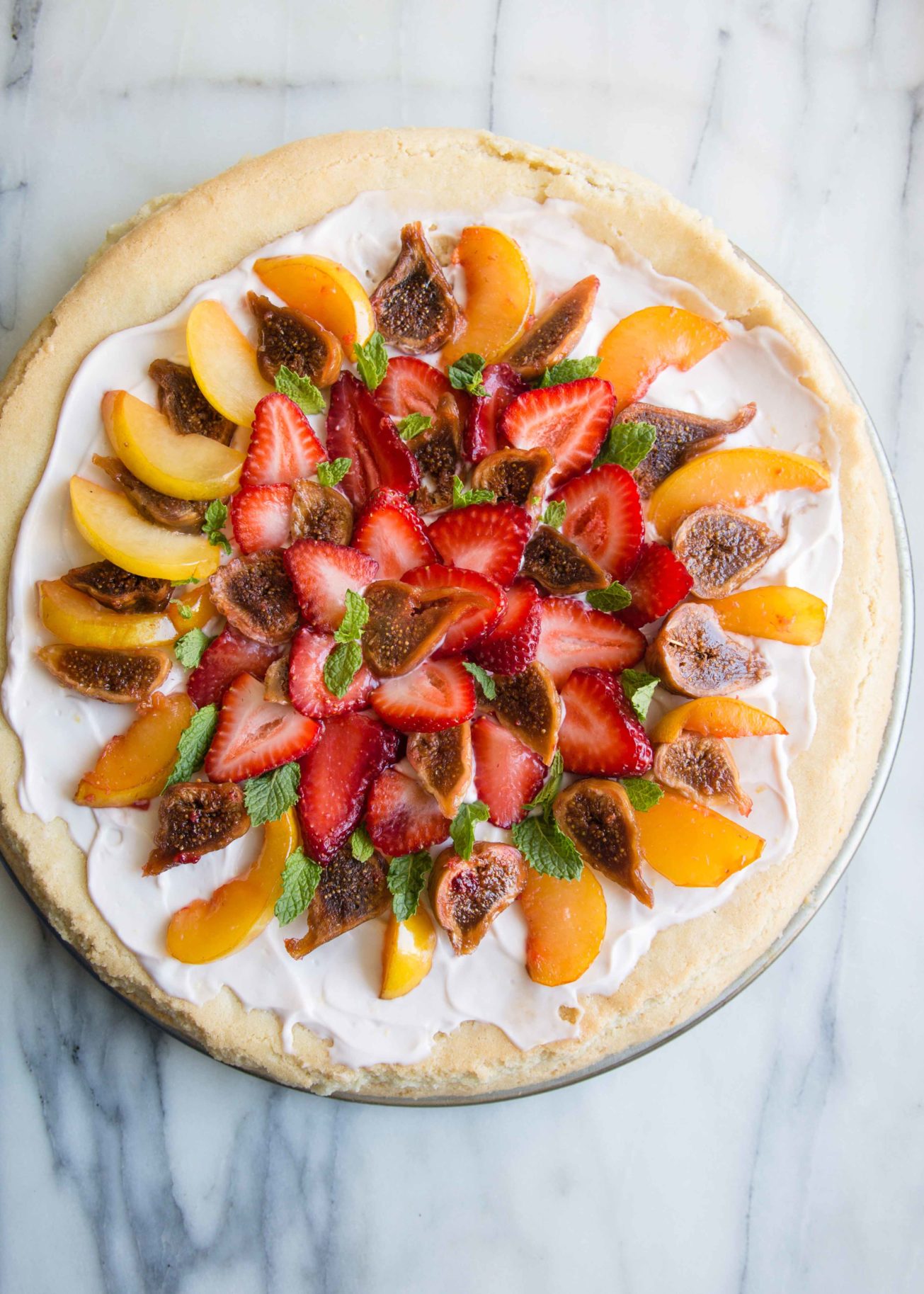 Fruit dessert lovers, make fruit pizza with sugar cookie dough. Top with stone fruits + dried figs for a fruit pizza recipe great in summer.
