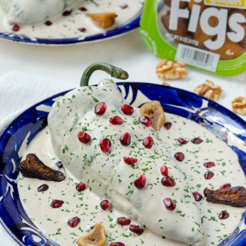Celebrate Mexican Independence Day. Creamy nut sauce + pomegranate top this vegan chile en nogada recipe filled with figs, nuts + fruits.