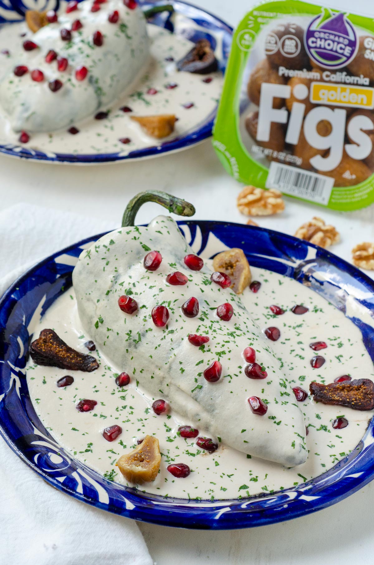 Celebrate Mexican Independence Day. Creamy nut sauce + pomegranate top this vegan chile en nogada recipe filled with figs, nuts + fruits.