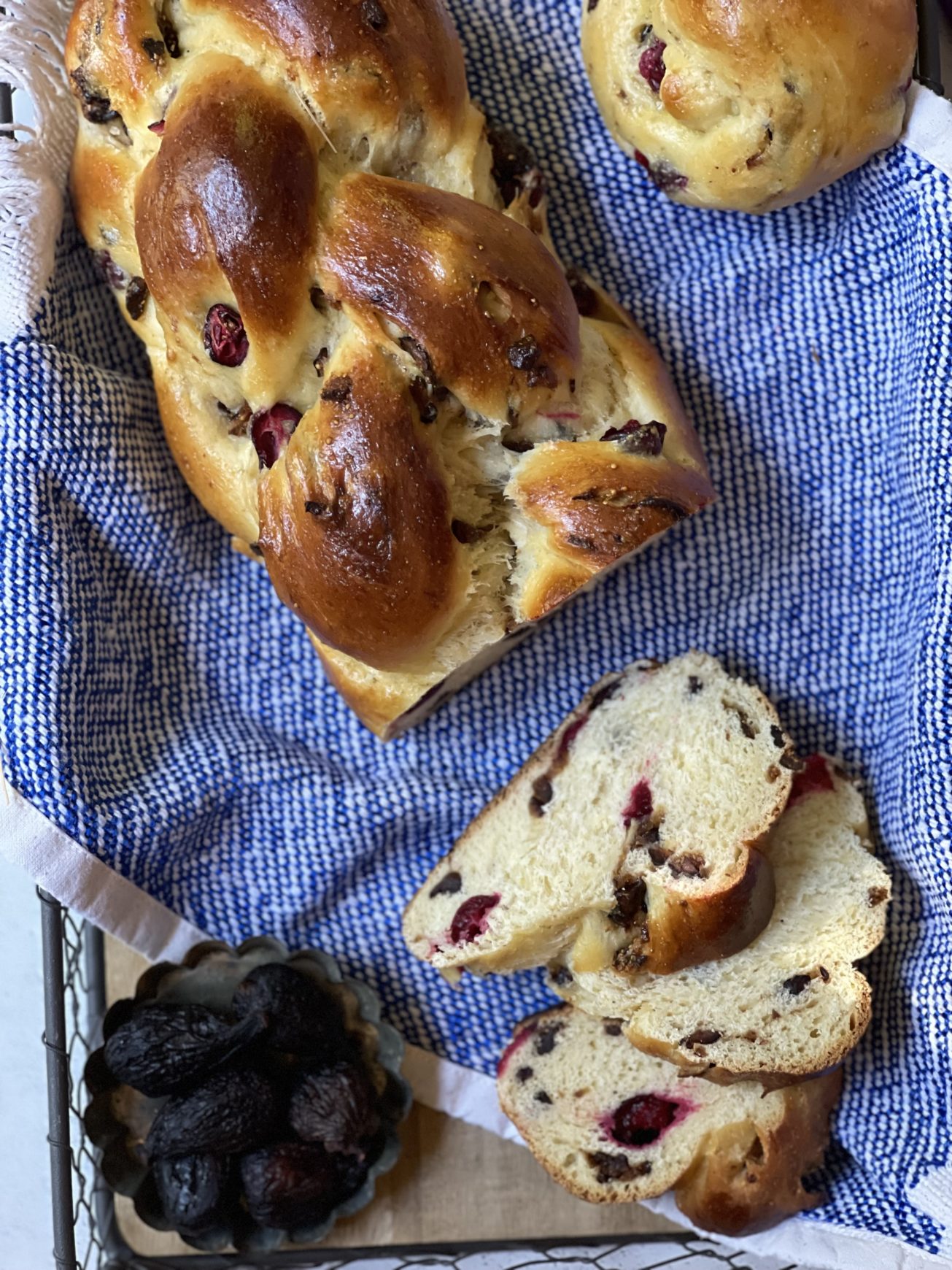 A loaf of fig challah bread with fig challah buns