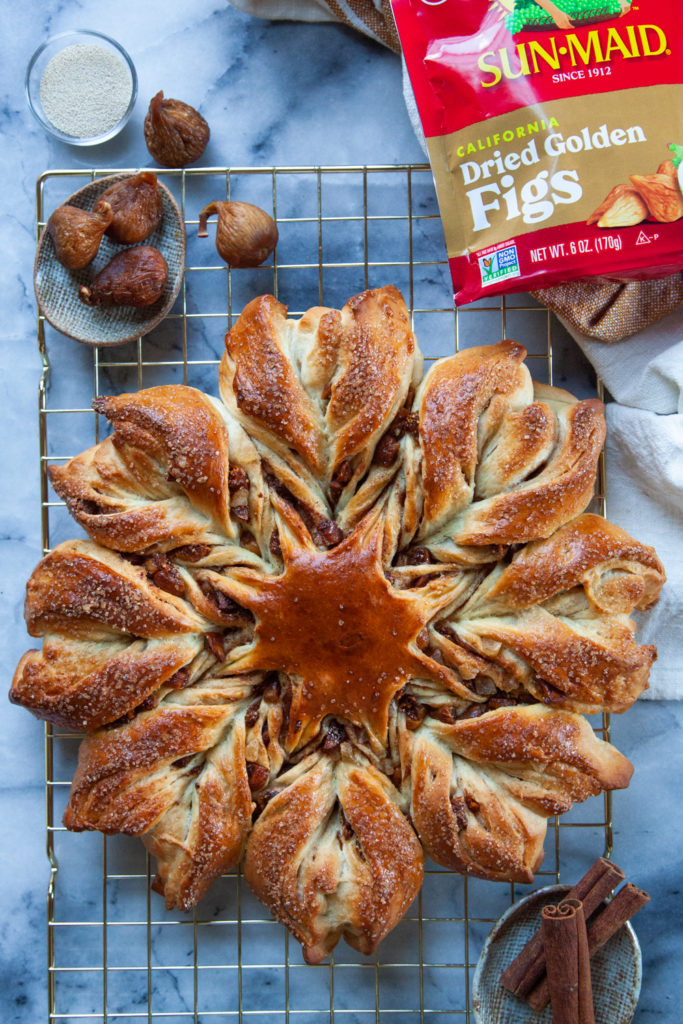 Cinnamon star bread on a wire rack with a bag of Sun-Maid Golden Figs  on the side.