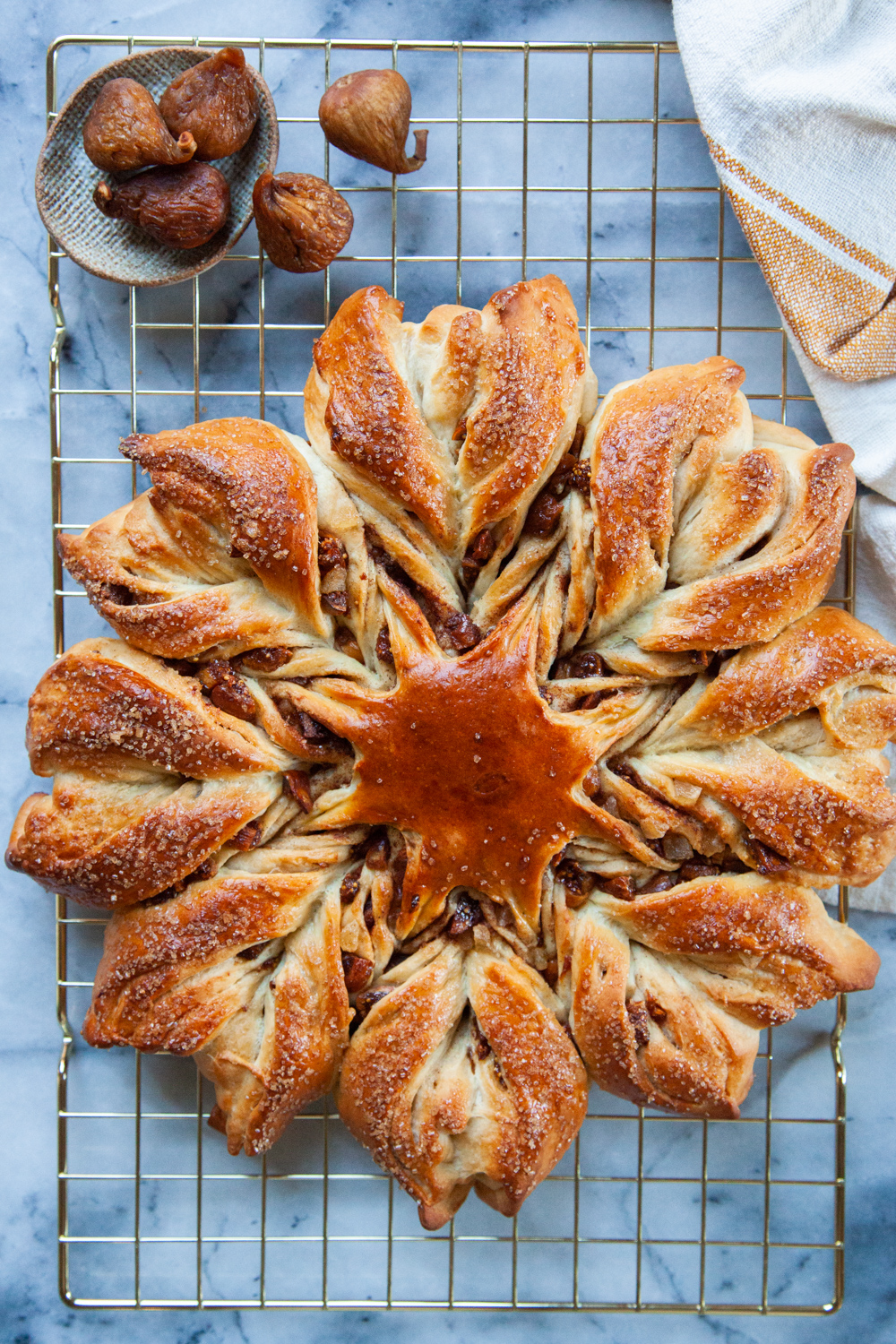 Cinnamon star bread on wire rack with Orchard Choice and Sun-Maid Golden Figs on the side in a bowl