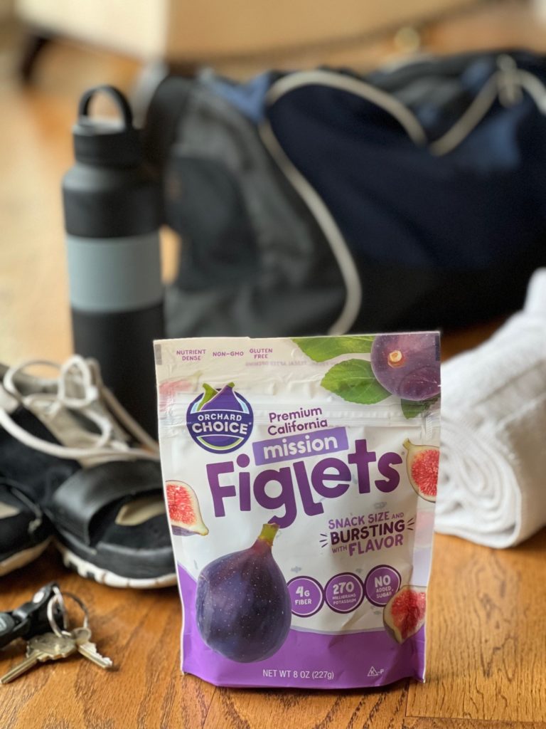 Dried fig nutrition in a bag of Orchard Choice Figlets and gym bag 