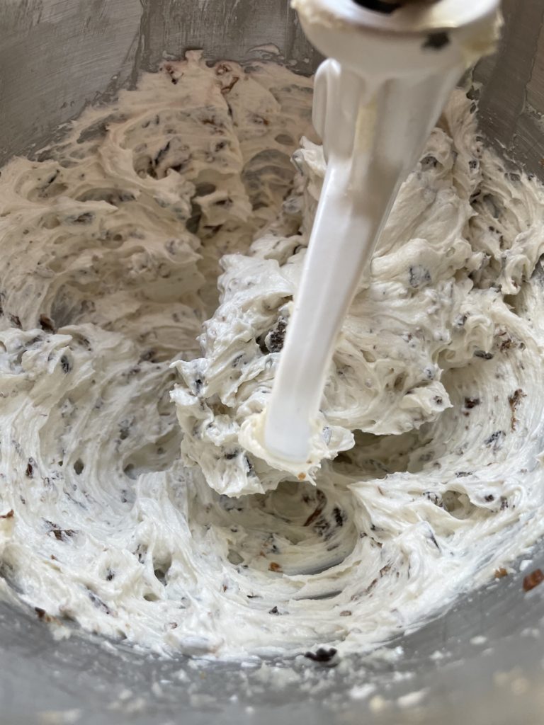 Creamy figgy non dairy cream cheese frosting right after beating it and mixing in the figs