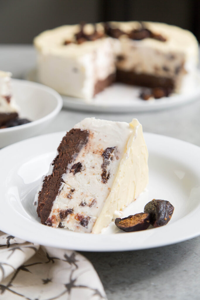 This fig cake recipe is made for summer. Chocolatey no-churn fig ice cream is sandwiched between white chocolate on top and fudge cake on the bottom.