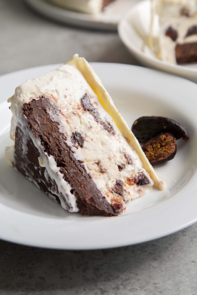 This fig cake recipe is made for summer. Chocolatey no-churn fig ice cream is sandwiched between white chocolate on top and fudge cake on the bottom.
