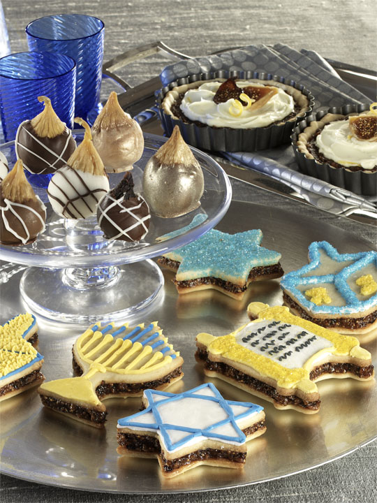 During the festival of lights, bake Hanukkah cookie recipes. Break out the icing to decorate festive Sandwich Hanukkah Cookies.