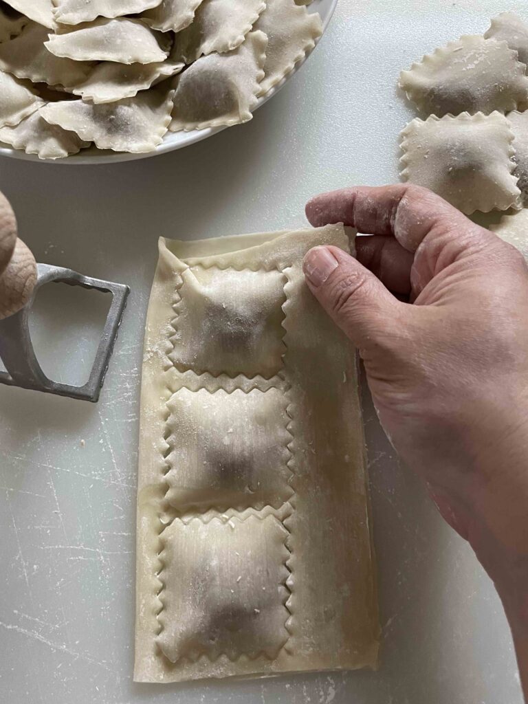 Stamping out the ravioli, all stuffed with fig goat cheese ravioli filling 