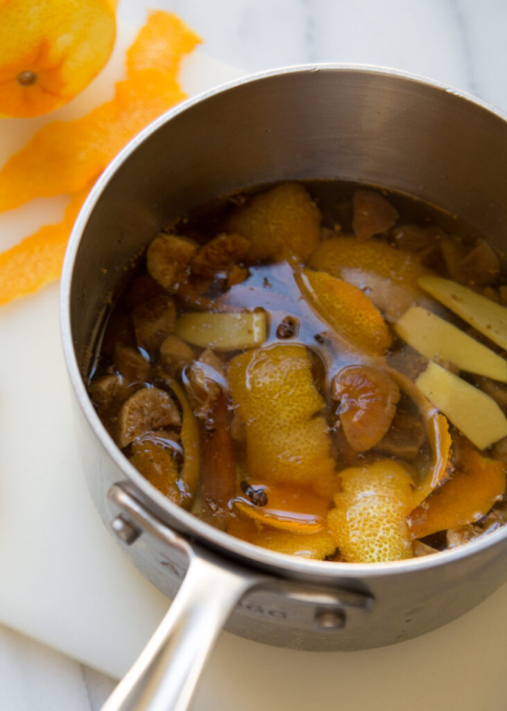 A saucepan with citrus zest, spices and Golden Figs.