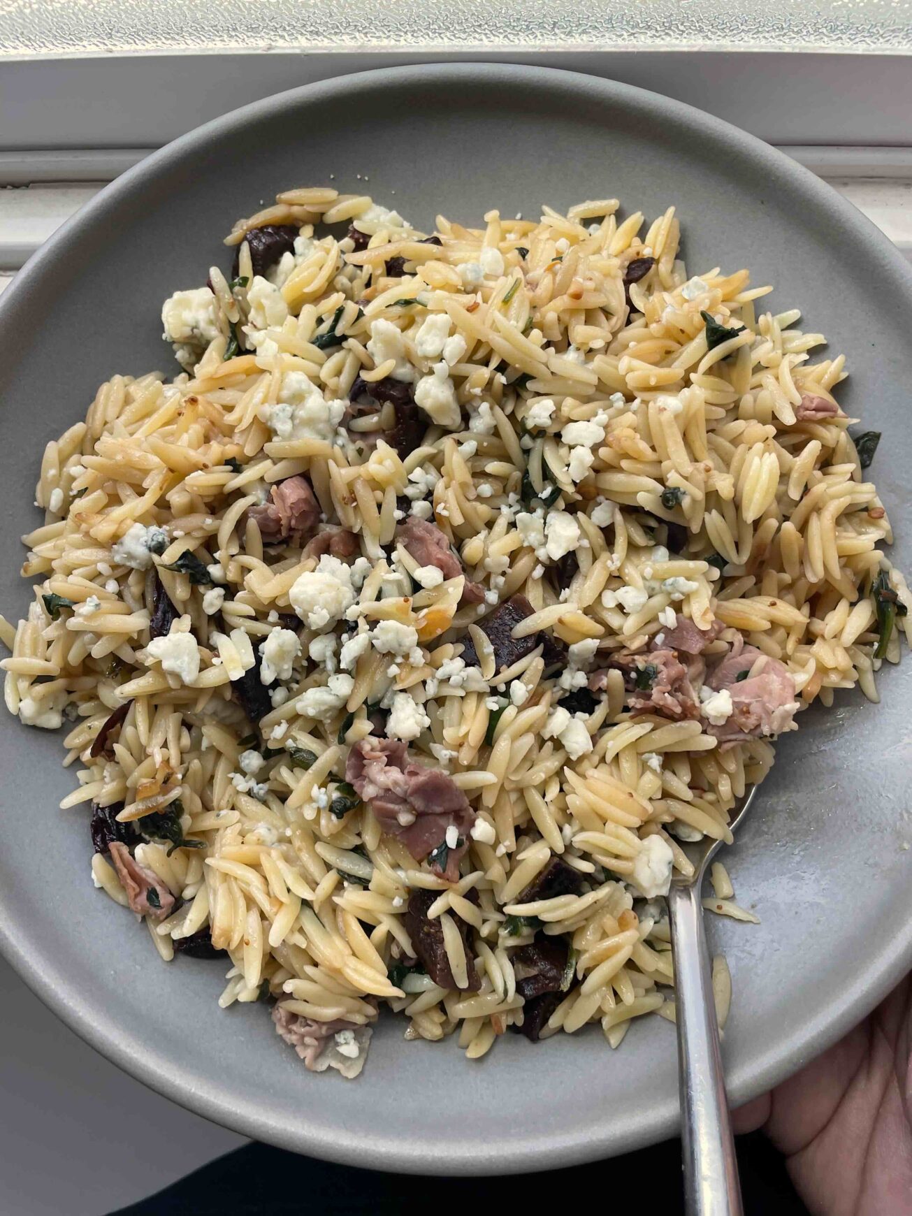 Grey bowl with orzo pasta and figs