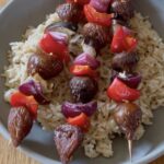 Veggie Fig Kebabs on a grey plate with brown rice