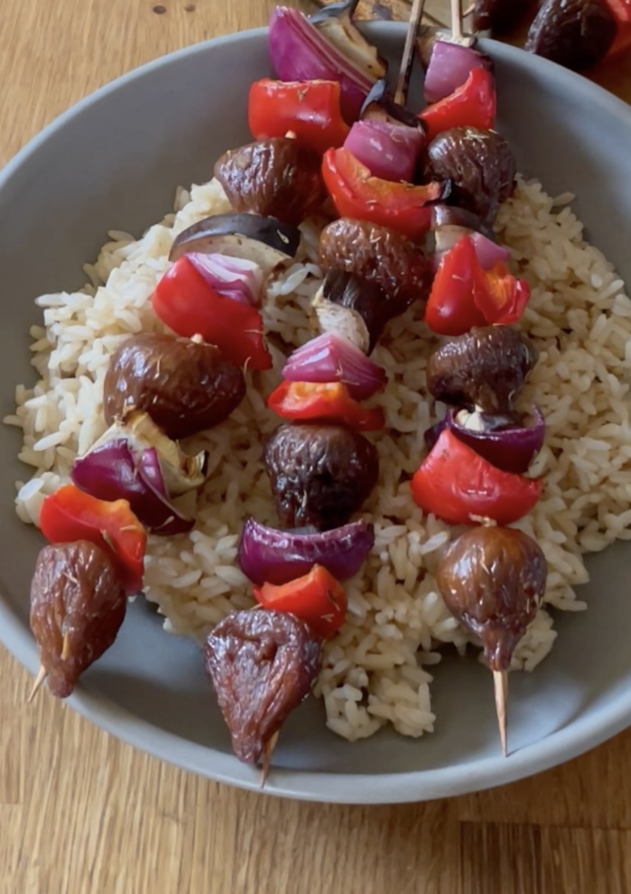 Veggie Fig Kebabs on a grey plate with brown rice