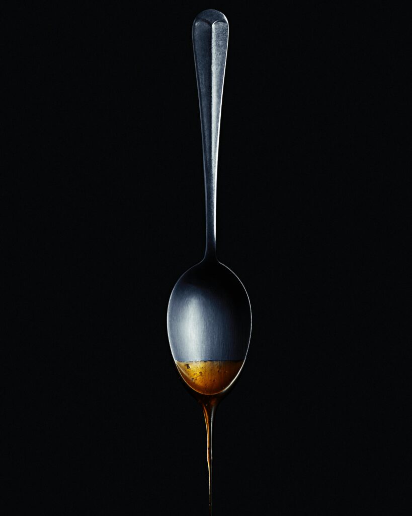 spoon with syrup dripping off of it